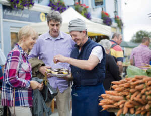 middle age woman and a man enjoying oysters in Galway Market
